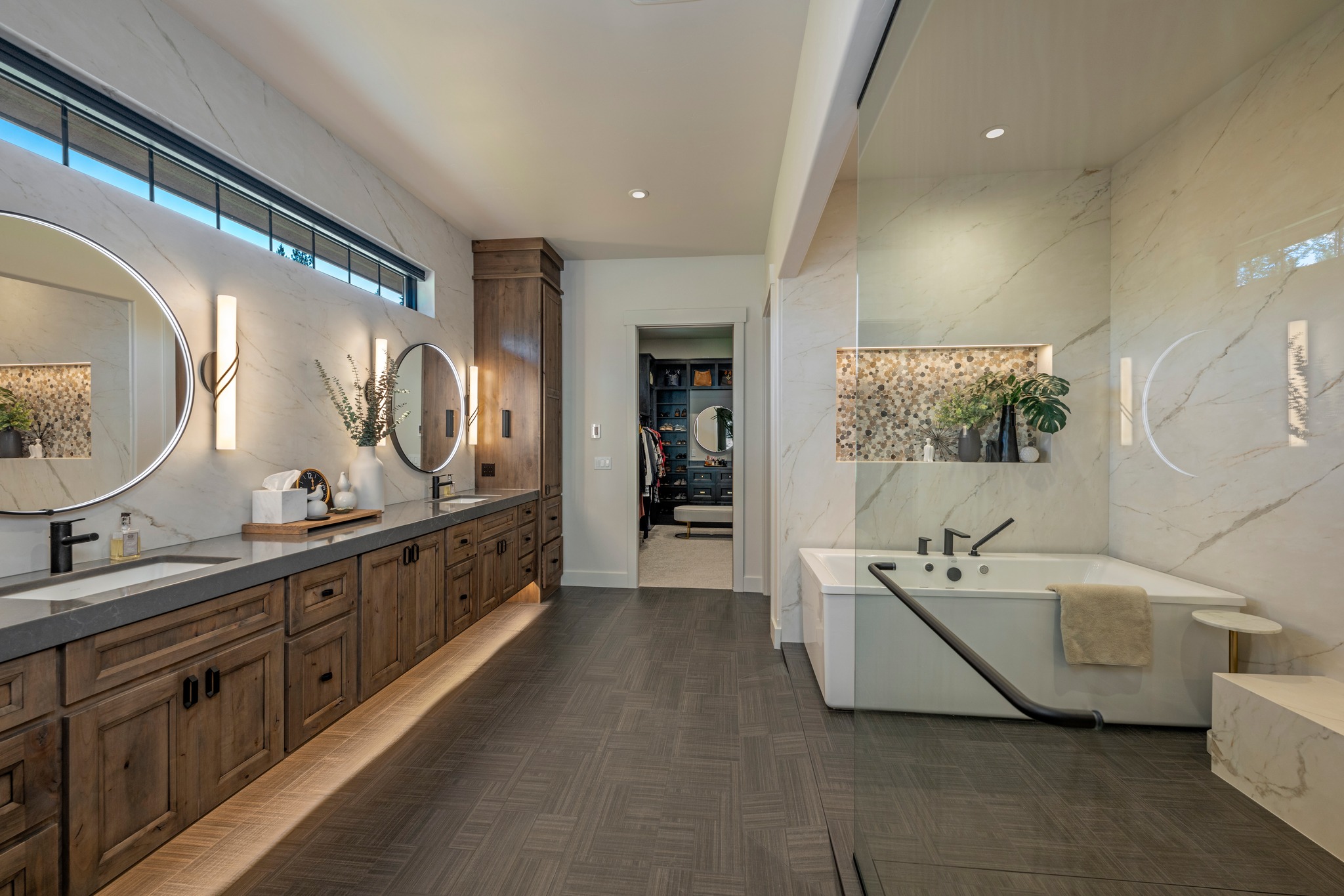 Special Touches for 'Forever Home'
.
"The ensuite area includes dual sinks and illuminated mirrors as well as accent windows that provide natural light. It also features a spacious ‘wet room’ with an enclosed bathtub and shower. Johnson said the homeowners, in their 50s, wanted to make sure they would be able to age in place well, so the room was designed not to include any barriers or anything that could lead to mobility challenges in the future."
.
Bulider: @rosenbergerconstruction 
By: Joe Butler
Photography by: @joelrinerphotography