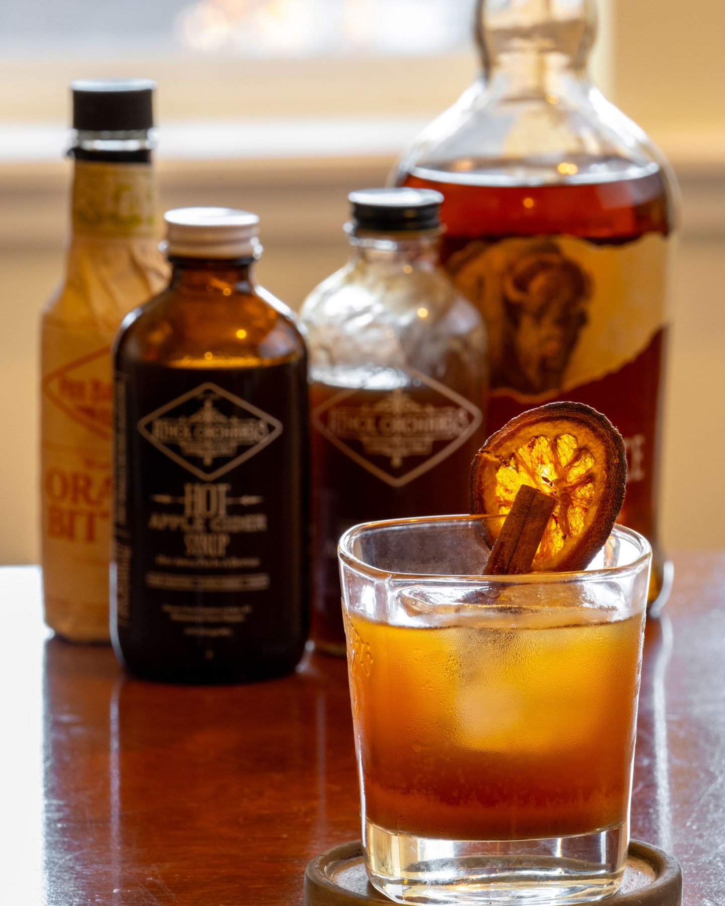 Apple Cider Whiskey Warmer
.
2 oz bourbon
1 oz Athol Orchards Apple Cider syrup
1 oz brewed Pu-erh black tea
Dash of orange bitters
1 cinnamon stick
1 dried or fresh orange wheel
.
By: @michalthewriter 
Photography by: @joelrinerphotography
