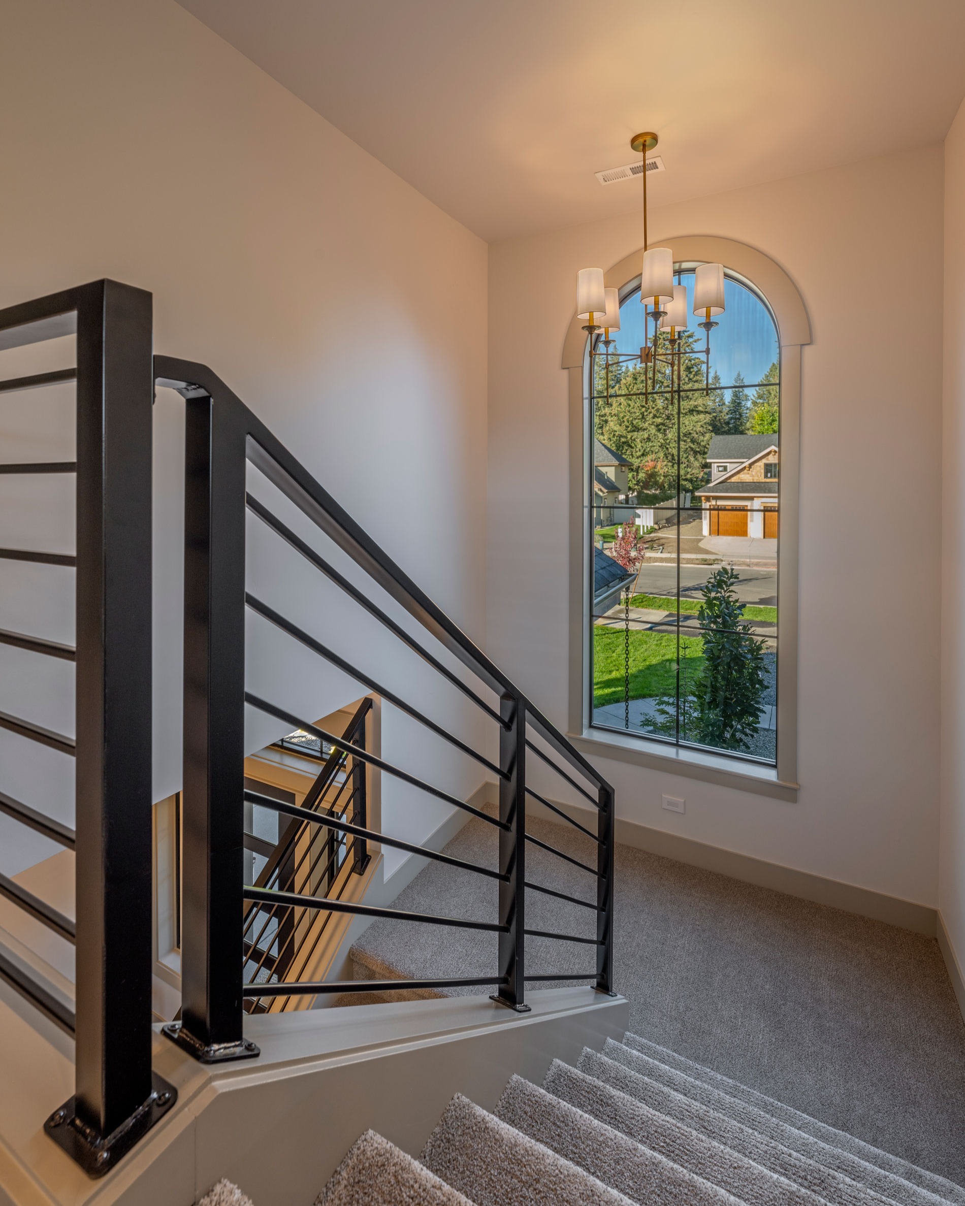 The Whistler Trail
.
"One of the first things to attract attention is a large arched window on the iconic stairwell projection, adjacent to the front door. It’s wrapped in stained shake and is designed to catch the eye and draw it upward. The entryway includes stone and wood pillars and a sitting area on the front porch. The landscaping also complements the natural tones."
.
Builder: Anthem Homes
.
By: Joe Butler
.
Photography by: @joelrinerphotography