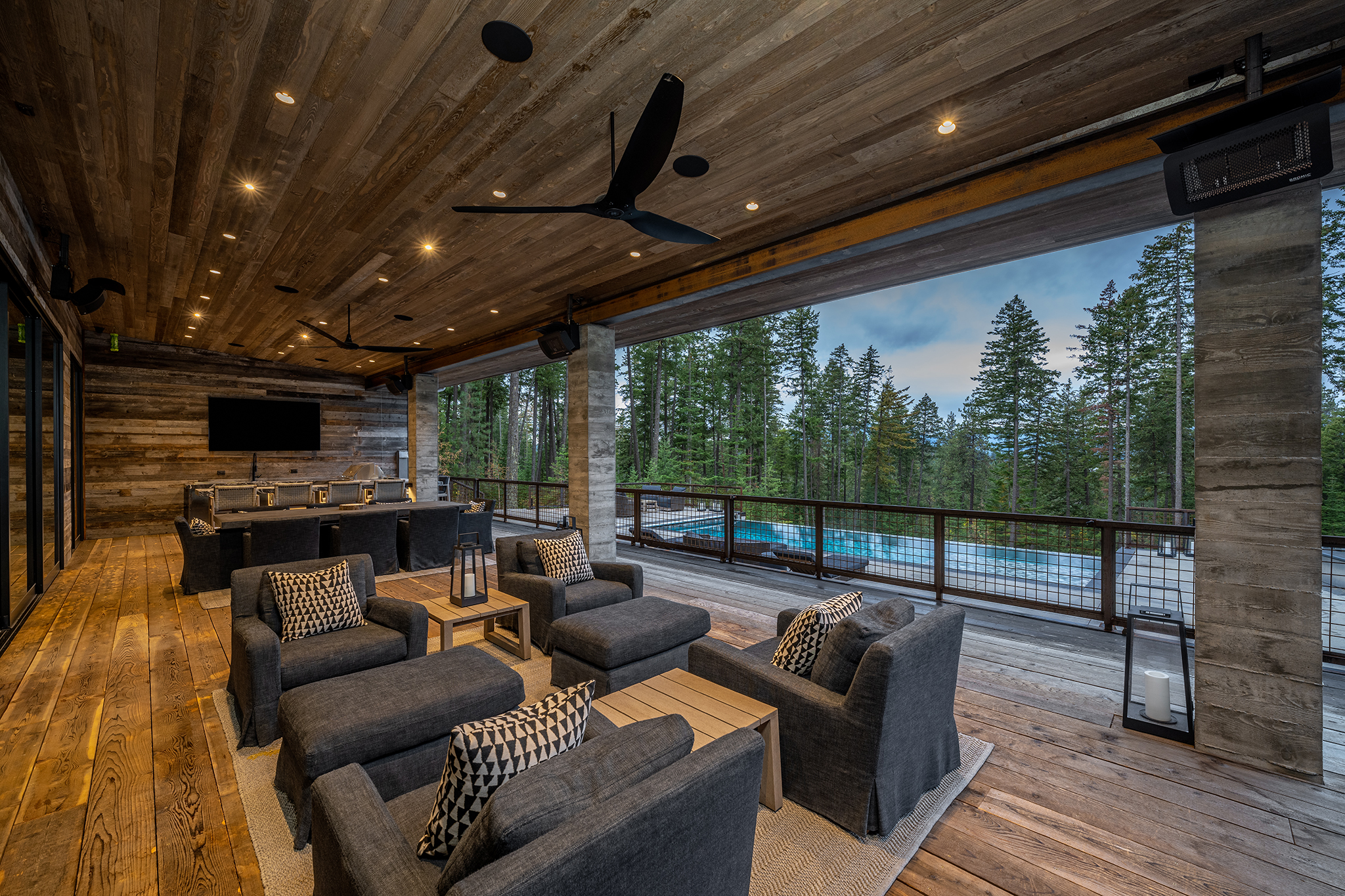 The covered deck space offers plenty of room for entertaining and a great view of the pool and surrounding trees.