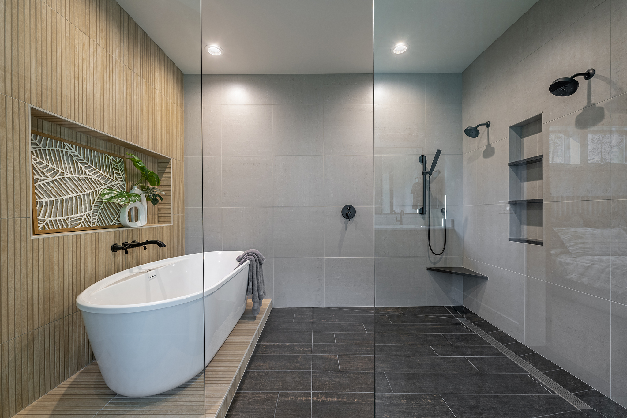 A large soaking tub and a series of shower heads can provide a relaxing experience in the master bedroom