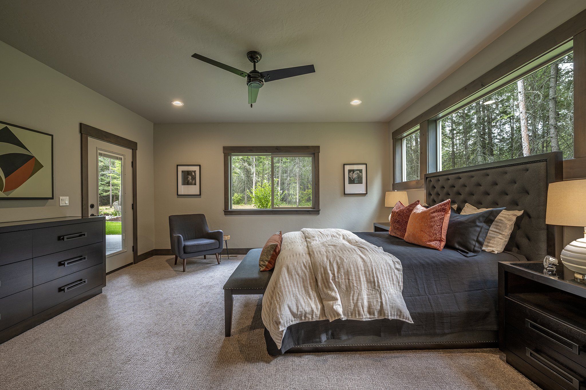 Emphasis on the scenery continues in the master bedroom, with two windows plus a glass-paneled door that accesses the patio and hot tub.